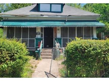 Charming single-story home with a porch, offering a cozy curb appeal in a mature neighborhood at 901 Mayson Turner Nw Rd, Atlanta, GA 30314