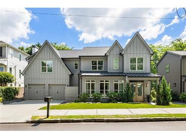Beautiful two story traditional gray home with a two car garage, green grass, and lovely landscaping at 3233 Osborne Ne Rd, Brookhaven, GA 30319