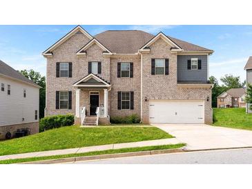 Beautiful two-story brick home featuring a manicured lawn and attached two car garage at 3692 Wartrace Dr, South Fulton, GA 30331