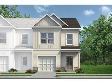 Charming townhome featuring a one-car garage and a welcoming front entrance with sidewalk appeal at 55 Alameda St # 6, Loganville, GA 30052