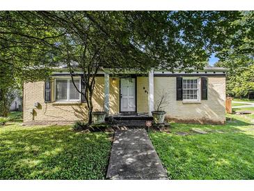 Charming single-story home with painted brick, black shutters, manicured lawn and walkway at 961 Lindbergh Ne Dr, Atlanta, GA 30324