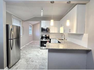 Modern kitchen features stainless steel appliances, granite countertops and stylish tile floors at 3254 Howell Cir, Duluth, GA 30096