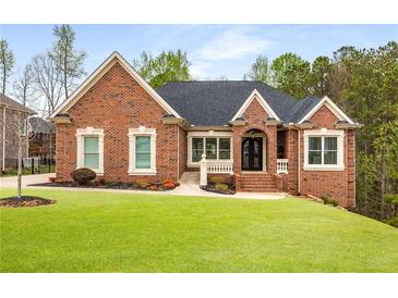 Beautiful brick home featuring a manicured lawn and charming architectural details at 4457 Equity Ct, Ellenwood, GA 30294