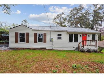 Charming single-story home featuring a bright red front door and a well-maintained lawn at 329 Cranfill Se Rd, Marietta, GA 30060