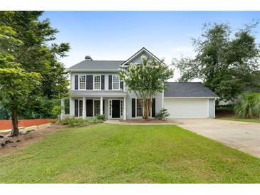 Charming two-story home featuring gray siding, black shutters and a well-manicured lawn at 3340 Deerwood Ln, Rex, GA 30273