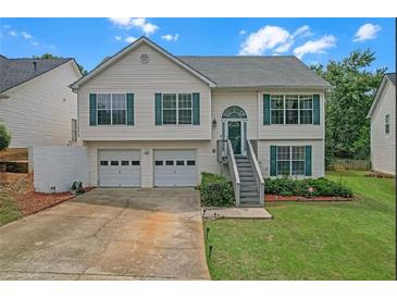 Charming two-story home with a two-car garage and well-maintained front yard at 3383 Spirit Nw Dr, Kennesaw, GA 30144