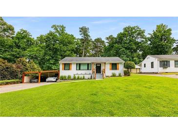 Charming single-story home with a well-manicured front yard, carport, and inviting curb appeal at 1981 Shalimar Ne Dr, Atlanta, GA 30345