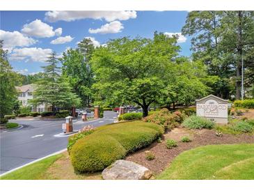 The community entrance welcomes you with lush landscaping and signage to Parkwood Place Condominiums at 1250 Parkwood Se Cir # 1213, Atlanta, GA 30339