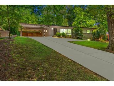 Charming single-story home with a long driveway and well-maintained lawn at 1492 Sagewood Cir, Stone Mountain, GA 30083