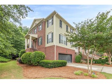 Charming brick and siding townhome with a two-car garage and manicured landscaping at 4228 Laurel Creek Se Ct # 6, Smyrna, GA 30080