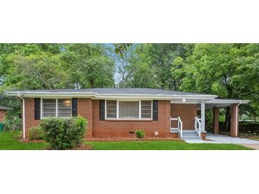 Charming brick ranch home with well-maintained landscaping and a convenient carport at 2858 Valley Ridge Dr, Decatur, GA 30032