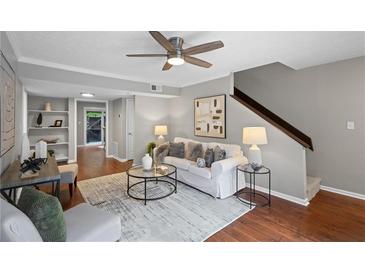 Cozy living room features hardwood floors, neutral decor, and a contemporary ceiling fan at 4960 Meadow Ln, Marietta, GA 30068