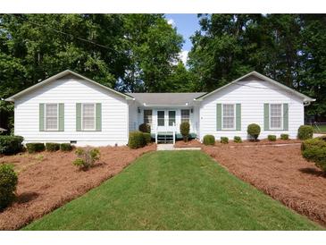 Charming single-story home with a well-manicured front lawn and inviting curb appeal at 402 Princeton Way, Lawrenceville, GA 30044