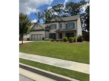 Beautiful two-story home with a well-maintained lawn and attached three-car garage at 2159 Holland Creek Ln, Buford, GA 30519