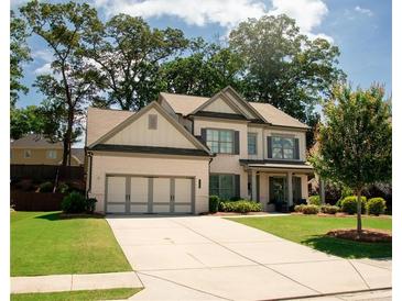Beautiful two-story home with well-manicured lawn, brick accents, and a two-car garage at 2159 Holland Creek Ln, Buford, GA 30519