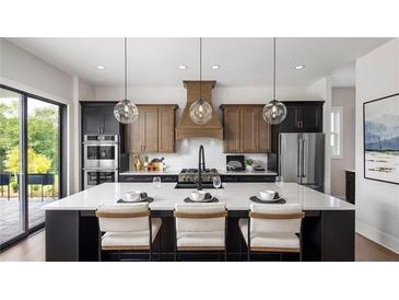 Beautiful kitchen featuring a large island, modern cabinetry, stainless steel appliances, and pendant lighting at 1063 Winding Branch Dr, Canton, GA 30114