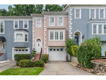 Charming townhomes in a row with colorful facades, driveways, and well-maintained landscaping at 3745 Meeting St, Duluth, GA 30096