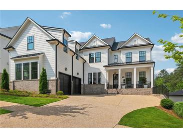 Stunning two-story home with white siding, brick accents, and a two-car garage at 4020 Connolly Ct, Roswell, GA 30075