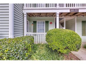 Charming condo with a covered porch and well-maintained landscaping at 301 Cobblestone Trl, Avondale Estates, GA 30002