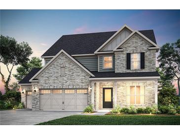 Charming two-story home featuring stone accents, a three-car garage, and professionally landscaped yard at 5220 Birch Valley Rd, Cumming, GA 30028