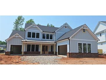 Charming new two-story home featuring board and batten siding, double garage, and a welcoming front porch at 4605 Aiden Way, Cumming, GA 30041
