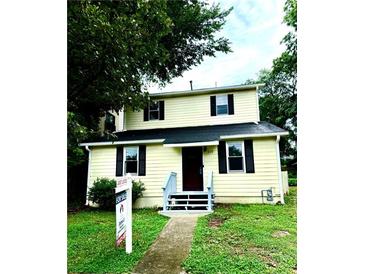 Charming two-story home with a manicured lawn and inviting front entrance at 210 Ormond Sw St, Atlanta, GA 30315