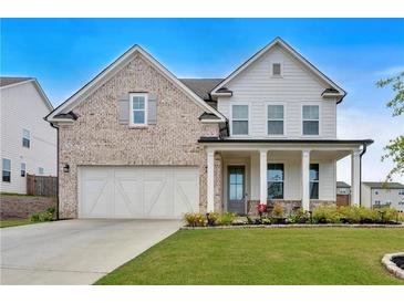 Charming two-story home with a brick and siding facade, well-manicured lawn, and an attached two-car garage at 87 Rushing View Gln, Dallas, GA 30157