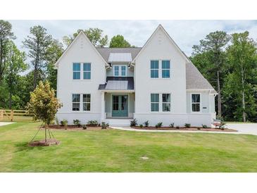 Charming two-story home with a well-maintained lawn and professional landscaping at 6545 Rhett Run, Cumming, GA 30028