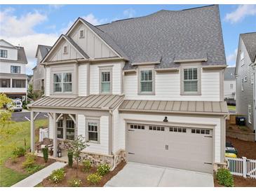 Charming two-story home with a two-car garage, landscaped yard, and covered porch at 1010 Fendley St, Woodstock, GA 30188