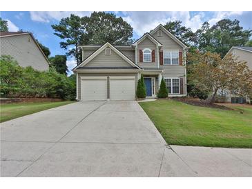 Charming two-story home with a well-maintained lawn and attached two-car garage at 5891 Buckner Creek Dr, Mableton, GA 30126