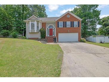 Charming two-story home with brick and siding, well-manicured lawn, and a two-car garage at 1010 San Marcos Cv, Lawrenceville, GA 30043