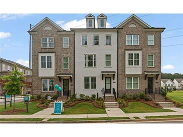Charming townhome exteriors feature a mix of brick and painted facades with manicured lawns at 114 Brackley Dr, Cumming, GA 30040