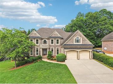 Charming brick two-story home featuring an attached two-car garage and landscaped front yard at 4508 Meadow Vista Trce, Lithonia, GA 30038