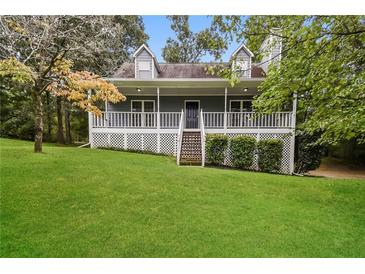 Charming home with a spacious front porch and beautifully maintained lawn, perfect for outdoor enjoyment at 4150 Sterling Pointe Dr, Douglasville, GA 30135
