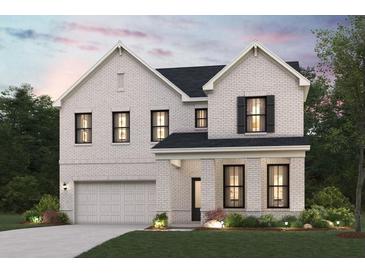 Stunning two-story white brick home featuring a two-car garage, covered porch, and well-manicured landscaping at 2048 Brookhill Way, Snellville, GA 30078
