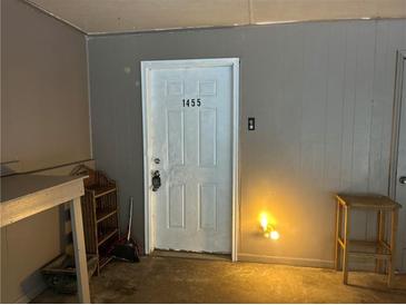 Image of the entrance door, numbered 1455, with a white painted finish and a small security peephole at 1455 Stone Mill Trce, Stone Mountain, GA 30083