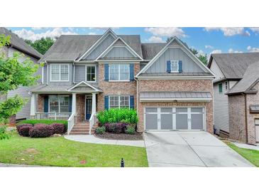 Beautiful two-story brick home featuring a manicured lawn and a two-car garage at 4590 Sierra Creek Dr, Hoschton, GA 30548