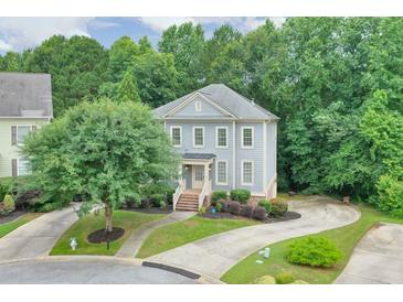 Charming two-story home with a landscaped front yard and driveway in a well-maintained neighborhood at 1223 Gathering Oaks Se Ct, Mableton, GA 30126