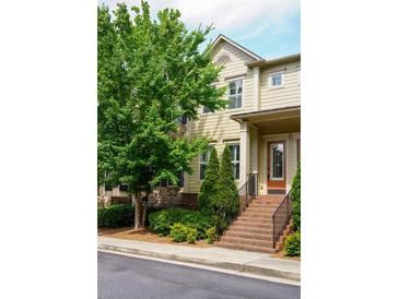 Traditional two-story townhome featuring a covered front entrance and landscaped yard at 1668 Sabastian Ne Pt, Atlanta, GA 30329