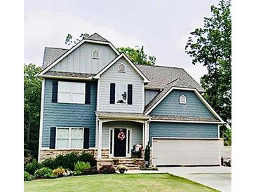 Charming two-story home with attached garage, manicured lawn, and inviting front entrance at 17 Kola Ln, Rydal, GA 30171
