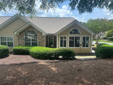 Inviting home featuring well-maintained landscaping, complemented by stone accents and large windows for ample natural light at 2191 Rockbridge Road # 2603, Stone Mountain, GA 30087