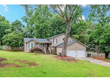 Charming home with a well-maintained front yard, beautiful tree, and inviting front porch at 252 Parkway Ct, Dallas, GA 30157