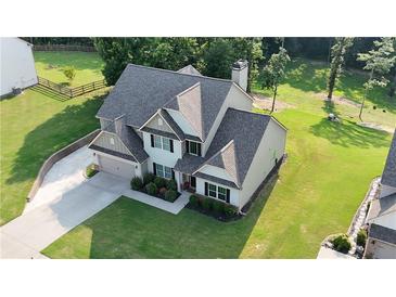 Stunning two-story home featuring a well-manicured lawn and attached two-car garage at 31 Thunderhawk Ne Ln, Rydal, GA 30171