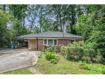 Charming brick home featuring a carport and front yard landscaping at 2875 Monterey Dr, Decatur, GA 30032