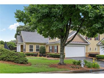 Charming two-story home with attached garage, well-maintained landscaping, and mature trees at 2721 Grapevine Cir # 1701, Cumming, GA 30041