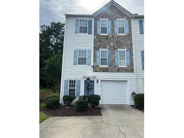Two-story townhouse with blue shutters, a garage, and partial stone facade at 4336 Thorngate Ln, Acworth, GA 30101