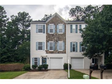 Charming townhome featuring stone accents, blue shutters, and a one-car garage at 4336 Thorngate Ln, Acworth, GA 30101