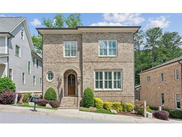 Charming two-story brick home with arched entry, manicured landscaping, and bright windows at 5971 Brundage Lane, Norcross, GA 30071