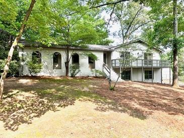 Charming, bright, one-story home with a deck and beautiful landscaping at 5384 Blackhawk Dr, Acworth, GA 30102