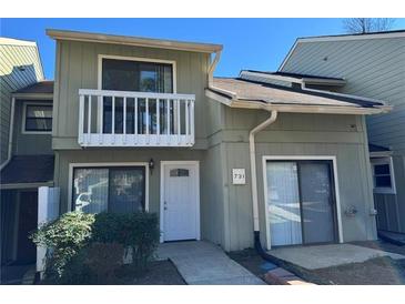 Charming two-story home featuring a balcony, modern siding, and well-maintained landscaping at 731 Hanover Se Ln, Marietta, GA 30067